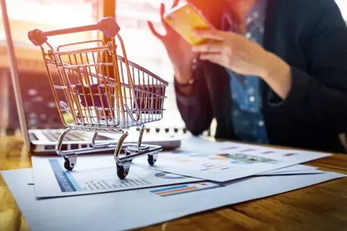 cropped-image-woman-inputting-card-information-key-phone-laptop-while-shopping-online-768x512