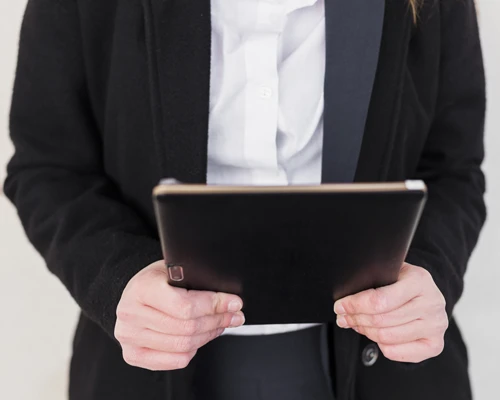 person-black-jacket-using-tablet